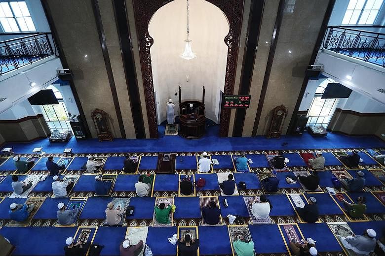 Ustaz Maaz Salim (top) leading congregants in prayer yesterday at Al-Istighfar Mosque (above), where afternoon prayers proceeded smoothly without any hiccups. People taking part in Friday congregational prayers at Al-Istighfar Mosque in Pasir Ris yes