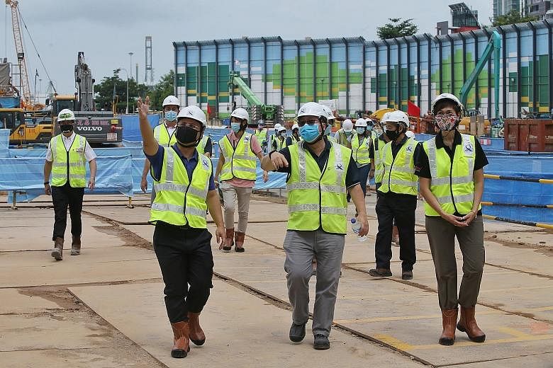 Mr Desmond Lee (left), Minister for Social and Family Development, and Mrs Josephine Teo (right), Minister for Manpower, being shown around the worksite of Circle Line's King Edward station yesterday. PHOTO: LIANHE ZAOBAO