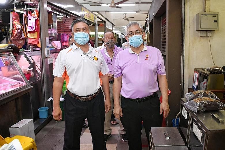 Democratic Progressive Party secretary-general Mohamad Hamim Aliyas (at left), accompanying People's Power Party secretary-general Goh Meng Seng, who is contesting MacPherson SMC, on his walkabout at MacPherson Market and Food Centre yesterday.