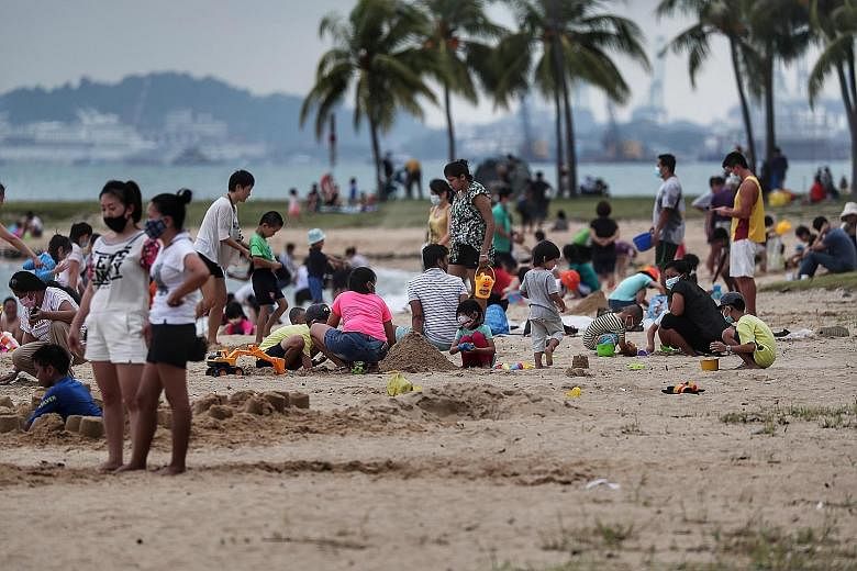 The beach at East Coast Park was busy yesterday, with people swimming, flying kites and having picnics. Groups were also spotted cycling, in-line skating and skateboarding beside the beach. ST PHOTO: KELVIN CHNG