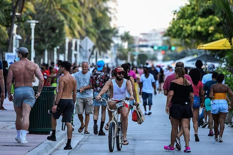 The Ocean Drive walkway in Miami Beach, Florida, was packed with crowds on Friday. There has been a surge in new coronavirus cases in southern and western US states, including Florida and Texas.