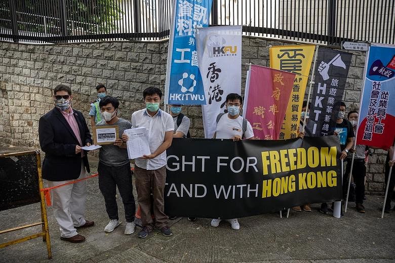 Union members submitting petition letters opposing China's national security legislation to a US consulate representative (far left) in Hong Kong on Friday. US Secretary of State Mike Pompeo said Washington will restrict visas to Chinese Communist Pa