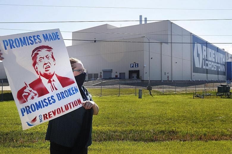 A protester calling for US President Donald Trump's election promises to be fulfilled, outside Lordstown Motors Corp in Warren, Ohio, on Thursday. US Vice-President Mike Pence was visiting the city to speak at the unveiling of a new all-electric pick