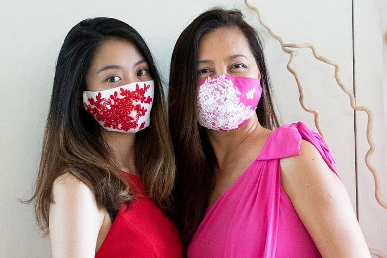 Couturier Ann Teoh and her daughter Christel wearing her hand-sewn limited-edition face masks, which are sold online, with 10 per cent of proceeds going to the Breast Cancer Foundation. 