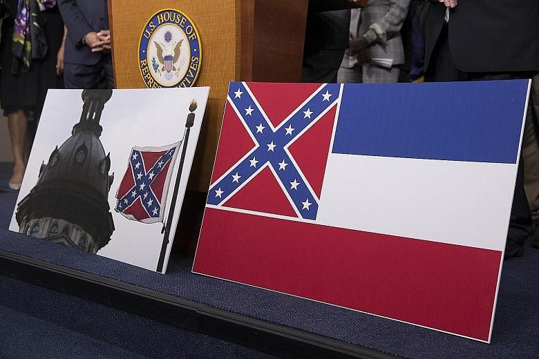 The Confederate battle flag flying in South Carolina (left) and the Mississippi state flag featuring the criss-crossed diagonal stars pattern. PHOTO: EPA-EFE