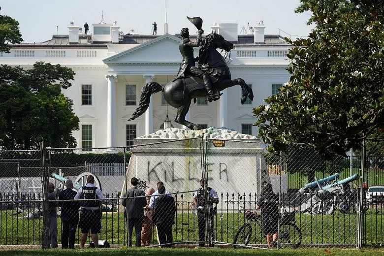 The word "Killer" is seen on the statue of former US president Andrew Jackson across from the White House last Tuesday, a day after a group of protesters attempted to knock down the statue as part of anti-racism rallies in the United States. Jackson 