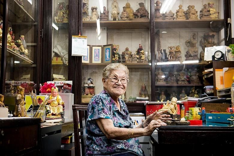 Madam Tan Chwee Lian (above), 89, family matriarch of Say Tian Hng Buddha Shop, carving wooden statues. The 124-year-old Taoist effigymaking shop is organising Design for Deities, an international competition calling for designers to reimagine a 40-year-o