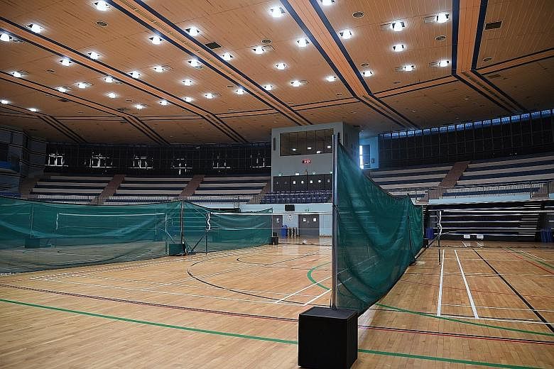 Mesh dividers between badminton courts at Jurong East Indoor Sports Hall, which was closed over the weekend. Of the 29-member group, over half are quarantined with the rest under phone surveillance.