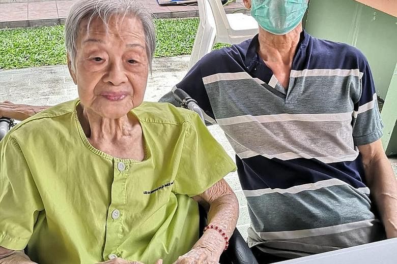 Madam Yap Lay Hong with her second son Alan Ho last Thursday at a designated outdoor area at Lee Ah Mooi Old Age Home, away from other residents.