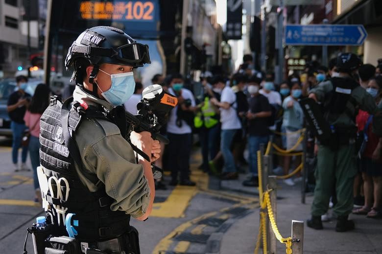A riot police officer standing guard to prevent mass gatherings during a protest against the looming national security legislation in Hong Kong yesterday.