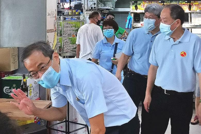 From left: The Workers' Party's Dennis Tan, Png Eng Huat and Low Thia Khiang on a walkabout in Hougang SMC yesterday. The party plans to field Mr Tan as its candidate for the SMC in the upcoming general election.