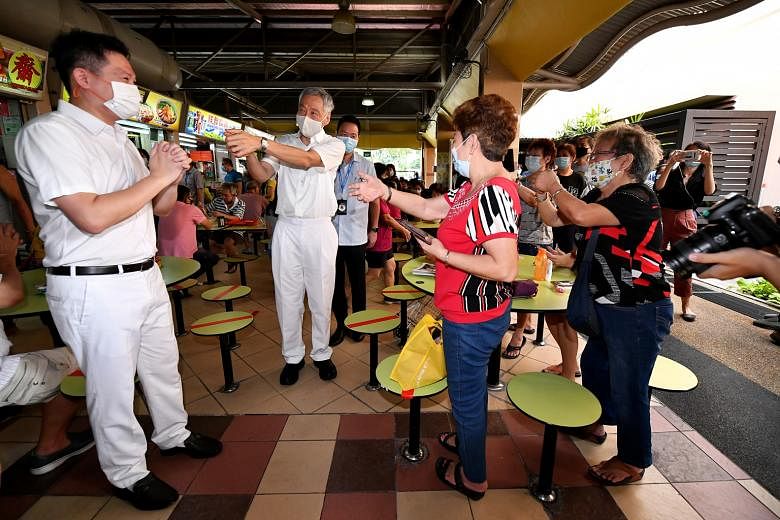 Prime Minister Lee Hsien Loong joined Mr Henry Kwek (at left) on a walkabout yesterday at Mayflower Market and Food Centre. Mr Kwek is an incumbent MP for Nee Soon GRC, in charge of Kebun Baru, which is now a single seat. Former Workers' Party (WP) c