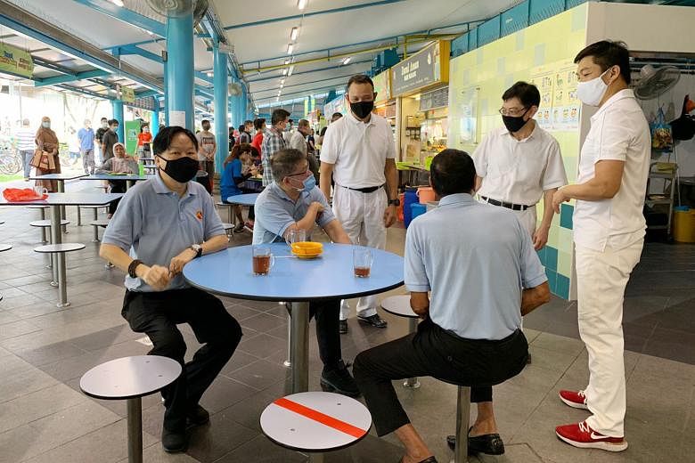 PAP's new candidate Desmond Tan greeting a resident at Loyang Point shopping mall yesterday. With him were fellow new face Mohamed Sharael Mohd Taha (second from right) and Mr Zainal Sapari (far right). PHOTO: TAMIL MURASU (From right) Speaker of Par