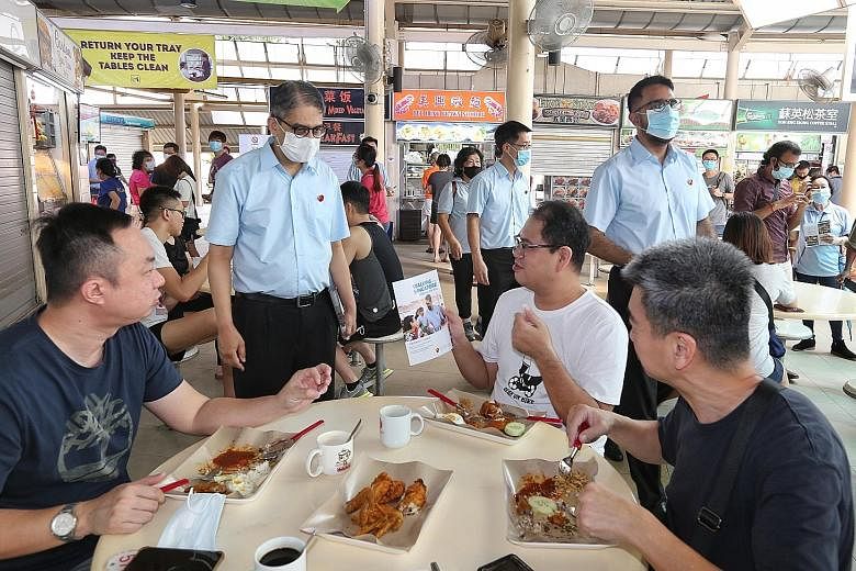 (From left) The Workers' Party's Mr Leon Perera, Mr Gerald Giam and party chief Pritam Singh at Serangoon Garden Market and Food Centre on Sunday. This year, the WP has scaled back its slate and placed all its parliamentarians into the two constituen