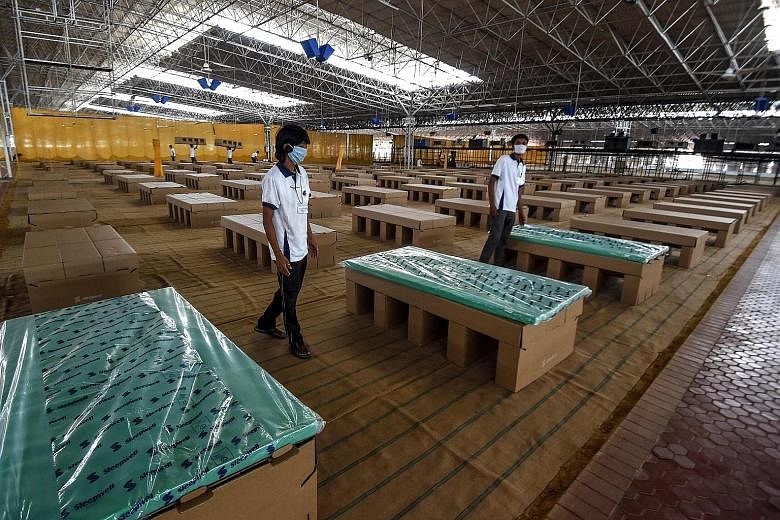 Cardboard beds installed inside a new 10,000-bed coronavirus care facility in Delhi. The facility, converted from a spiritual organisation's campus hall covering an area the equivalent of 16 soccer fields, is set to be fully operational this week. PH