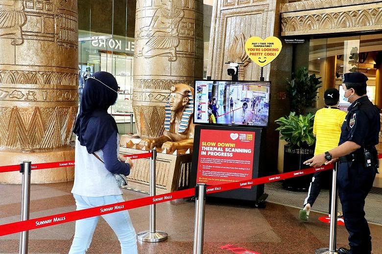 Visitors to Sunway Pyramid mall (above) and Suria KLCC (left) have to pass through thermal scanners to check their temperature and practise social distancing, among other measures. PHOTOS: SUNWAY MALLS, SURIA KLCC