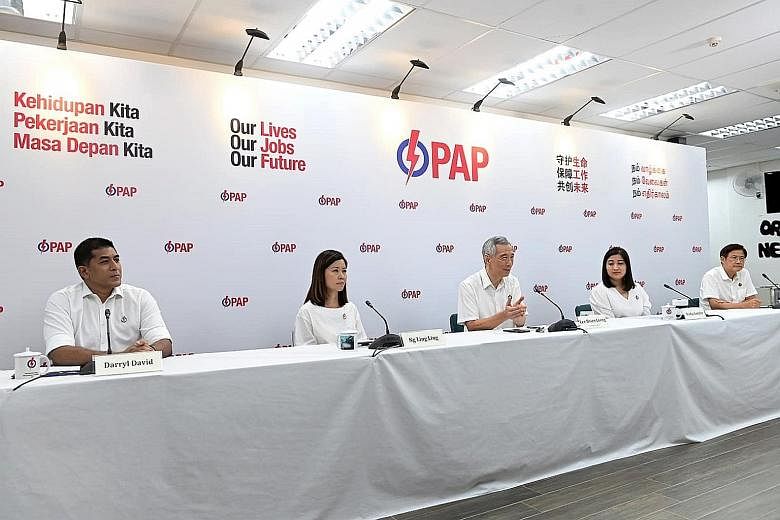 Prime Minister Lee Hsien Loong at yesterday's unveiling of candidates for Ang Mo Kio GRC, which he helms. The other members of the PAP's team in Ang Mo Kio GRC are (from left) Mr Darryl David, Ms Ng Ling Ling, Ms Nadia Ahmad Samdin and Mr Gan Thiam P
