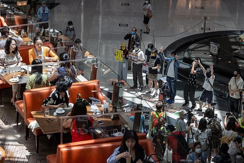 Pro-democracy protesters taking part in a "lunch with you" rally at a shopping mall in Hong Kong yesterday, after China's Parliament approved a national security law for the city that prohibits acts of subversion and secession. Many Hong Kongers fear