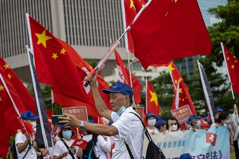 Pro-China supporters at a rally in Hong Kong yesterday. The new national security law effectively bans the sort of protests that have rocked the city for most of the past year, criminalising subversion and collusion with foreign forces. It was promul