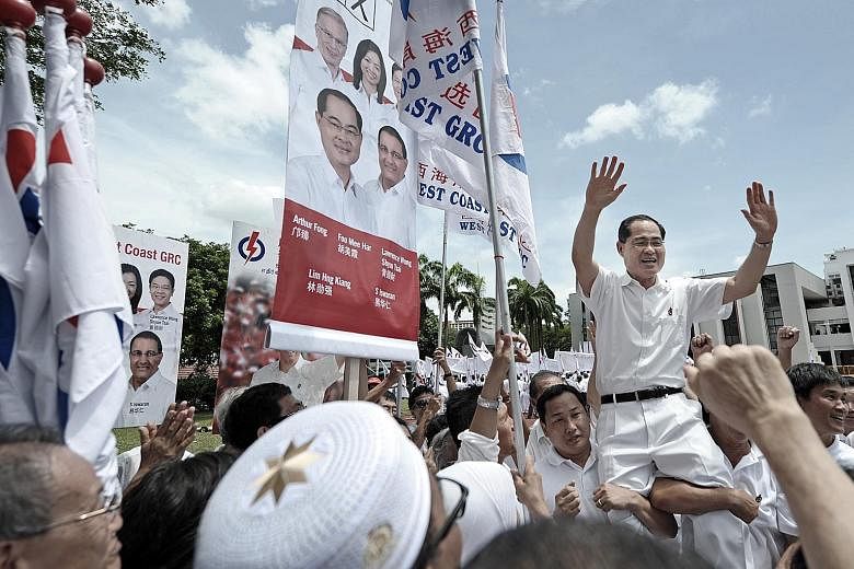 People's Action Party supporters hoisting PAP candidate for West Coast GRC, Mr Lim Hng Kiang, onto their shoulders at the Jurong Junior College nomination centre on April 27, 2011. Mr Lim's team went on to beat the Reform Party at the polls that year