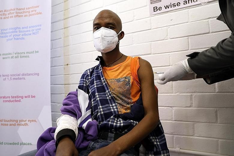 A man getting an injection during a clinical trial for a potential Covid-19 vaccine at the Baragwanath hospital in Soweto, South Africa, on June 24. The world faces problems of how to produce enough vaccines to meet global demand, and how to ensure i