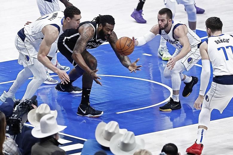 Brooklyn's DeAndre Jordan (in black, playing against Dallas in January) announced on Monday that he had contracted Covid-19. The centre will not feature when the NBA resumes on July 30. PHOTO: EPA-EFE
