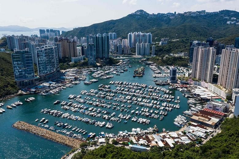 Residential buildings in Aberdeen Harbour, Hong Kong. Gains in home prices were helped by low interest rates and pent-up demand as the economy gradually picked up after the Covid-19 outbreak. PHOTO: AGENCE FRANCE-PRESSE