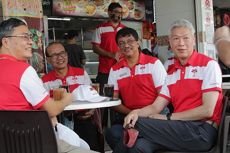 Mr Lee Hsien Yang (at right) with three members of the PSP's Tanjong Pagar GRC team - (from left) Mr Michael Chua, Mr Abas Kasmani and Mr Harish Pillay - at a coffee shop near the nomination centre for Tanjong Pagar GRC yesterday morning. ST PHOTO: G