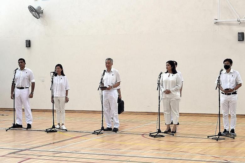 Prime Minister Lee Hsien Loong addressing voters with his Ang Mo Kio GRC team - (from left) Mr Darryl David, Ms Ng Ling Ling, Ms Nadia Ahmad Samdin and Mr Gan Thiam Poh - at the Deyi Secondary School nomination centre.