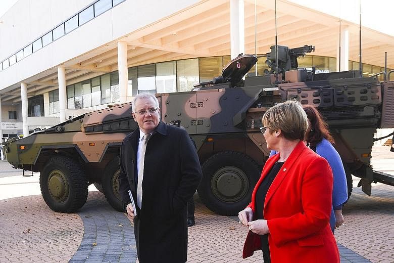 Australian Prime Minister Scott Morrison and Defence Minister Linda Reynolds arriving at the Australian Defence Force Academy in Canberra yesterday to speak at the launch of the 2020 Defence Strategic Update. Mr Morrison has earmarked A$270 billion (