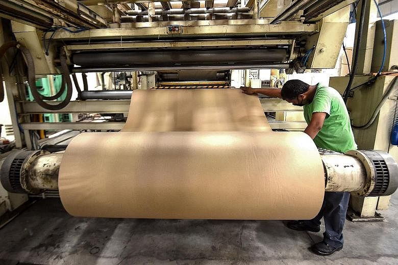 A factory in Rajasthan, India, churns out cardboard for makeshift beds for the country's surging numbers of Covid-19 patients. A car factory in Weifang in China's Shandong province. China's factory activity picked up pace last month after the country