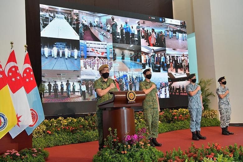 Above: Defence Minister Ng Eng Hen presenting the State Colours to Lieutenant-Colonel Fabian Pwi, Commanding Officer of the 1st Commando Battalion, which won the Best Combat Unit award this year. Left: Chief of Defence Force, Lieutenant-General Melvy