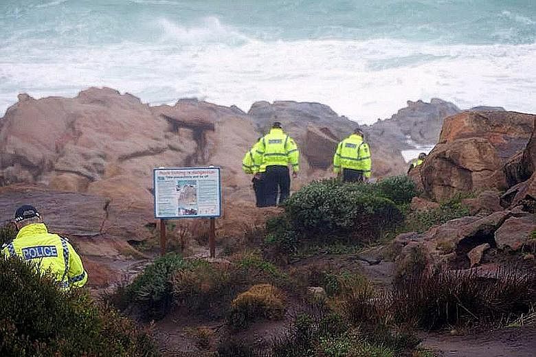 Police officers searching for the Singaporean - identified by the Western Australia Police Force as Mr Goh Heng Yi - who was said to be standing on a rock formation when a large wave knocked him into the ocean on Monday. PHOTO: ABC SOUTH WEST
