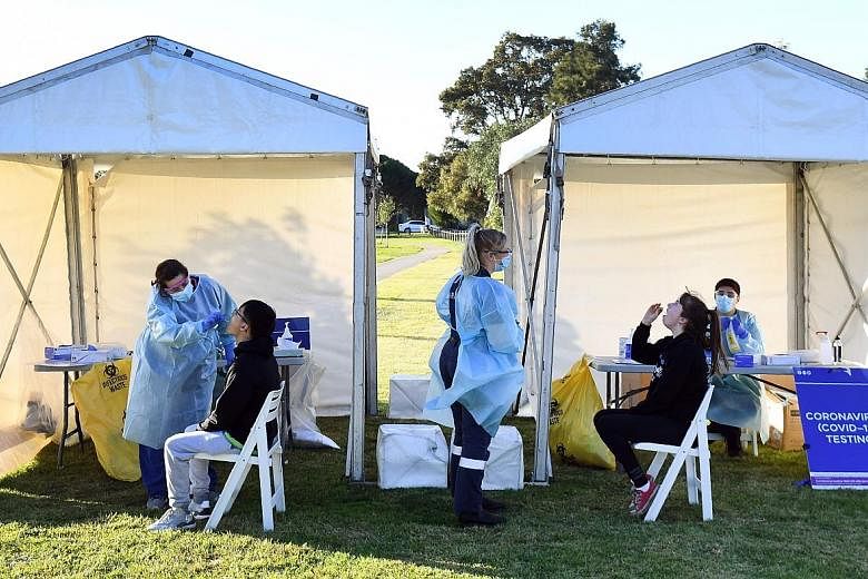 People having their swab samples taken to be tested for the coronavirus in a suburban park in Melbourne yesterday. PHOTO: AGENCE FRANCE-PRESSE