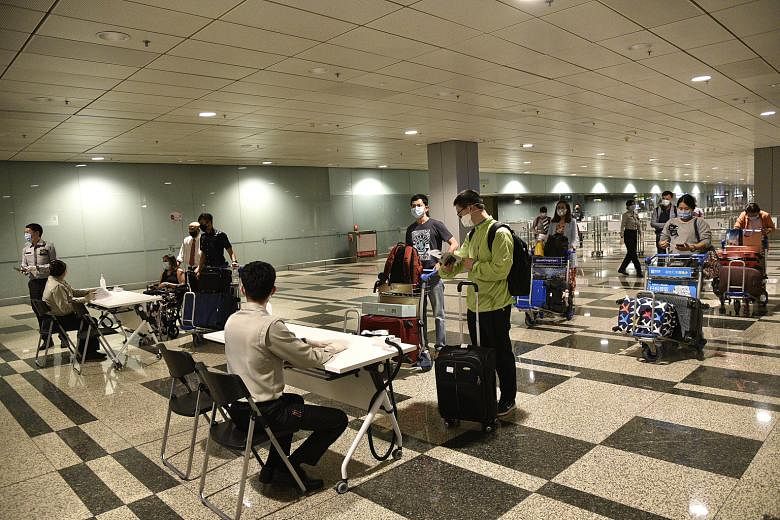Aviation security staff at Changi Airport in May assigning hotels to returning Singaporeans and permanent residents to serve their stay-home notice in. For voters who are on stay-home notice at hotels, polling teams will go door to door on July 10 to