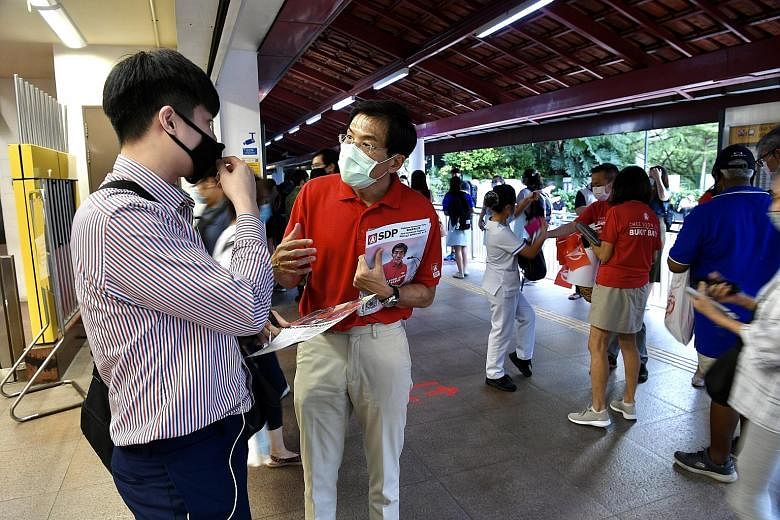 SDP chief Chee Soon Juan, seen here at a walkabout at Bukit Batok MRT station yesterday, was called on by the PAP to clarify his stance. ST PHOTO: DESMOND FOO