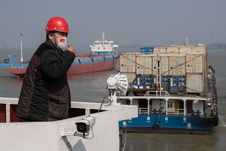 Container ships at the port of Wuhan. China is the 12th country to sign a pact launched by Singapore and New Zealand to uphold trade connections during the pandemic. PHOTO: AGENCE FRANCE-PRESSE