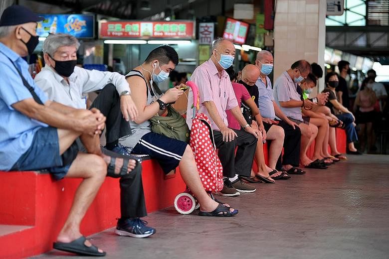 Residents wearing masks outside Chong Pang Market & Food Centre in Yishun. Singapore entered phase two of its reopening on June 19, with more shops reopening and people allowed to dine in and visit one another, as long as they follow guidelines such 