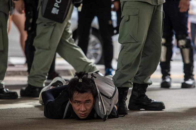 A protester in Hong Kong being detained during a rally against a new national security law on Wednesday.
