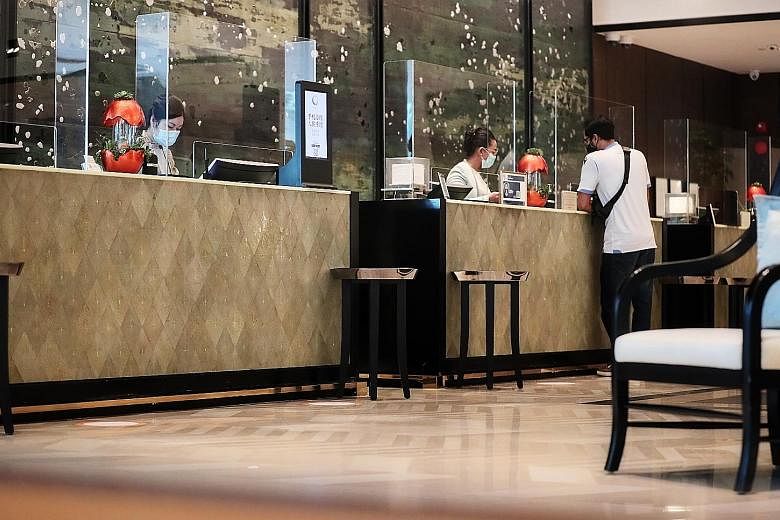 The Shangri-La Hotel's reception counters, fitted with plastic shields to minimise contact as part of safe management measures against Covid-19. The Singapore Tourism Board said hotels must implement measures such as staggering the check-in and check