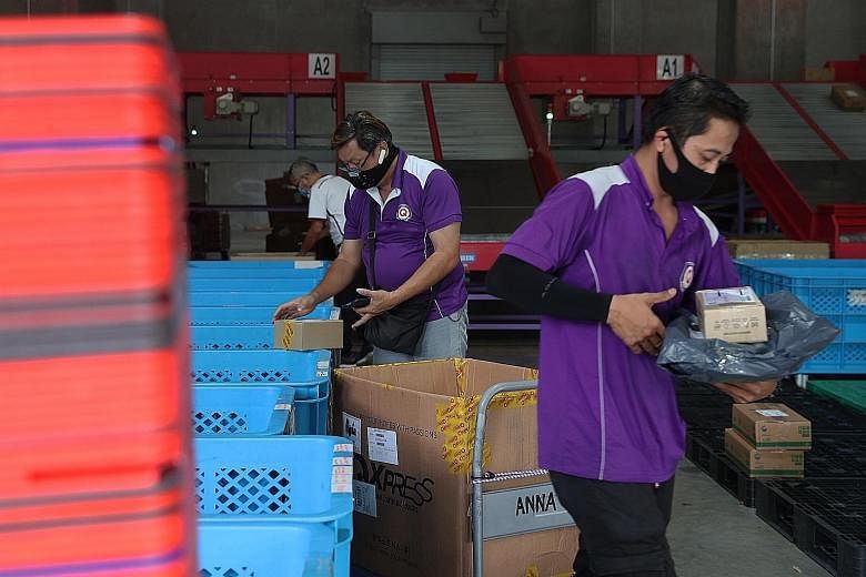 Qoo10 staff at work in the company's sorting facility. The firm is among the e-commerce marketplaces that have signed memoranda of intent with Pick Network to allow their customers to collect their online orders from Pick's 1,000 parcel locker statio