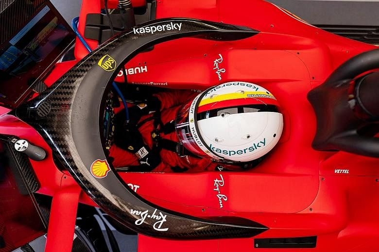 Sebastian Vettel waiting in the cockpit as his team prepare his Ferrari for the first practice of the Austrian Grand Prix at the Red Bull Ring yesterday. The F1 season, suspended just before the opening race in Melbourne in March, resumed behind closed do