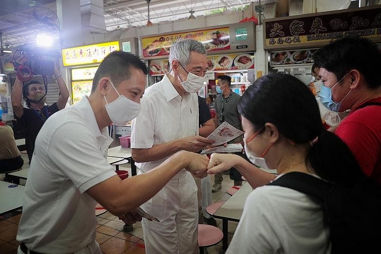 PAP candidates for Bishan-Toa Payoh GRC (from right) Ng Eng Hen, who is Defence Minister, Saktiandi Supaat and Chong Kee Hiong on a walkabout in Toa Payoh Central on Thursday. ST PHOTO: SHINTARO TAY The PAP's candidate for Bukit Batok SMC Murali Pill