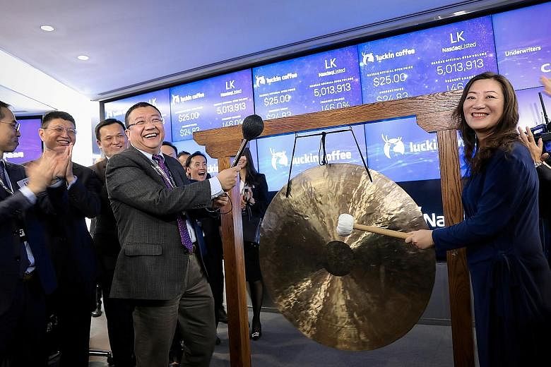 Luckin Coffee's chairman Charles Lu Zhengyao and then chief executive Jenny Qian Zhiya celebrating the company's initial public offering at the Nasdaq MarketSite in New York in May last year. 
