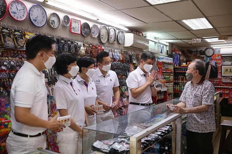 Trade and Industry Minister Chan Chun Sing greeting a shopkeeper on a visit to ABC Brickworks Market and Food Centre yesterday, with fellow members of the PAP team for Tanjong Pagar GRC (pictured from left) Alvin Tan, Joan Pereira, Indranee Rajah and