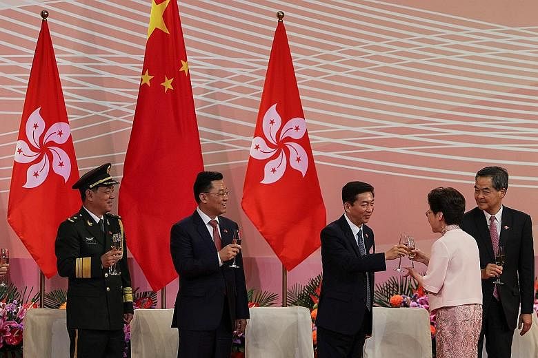 Hong Kong Chief Executive Carrie Lam and Mr Luo Huining, head of China's liaison office in the territory, clinking glasses at a ceremony to mark the city's handover anniversary last Wednesday. PHOTO: REUTERS
