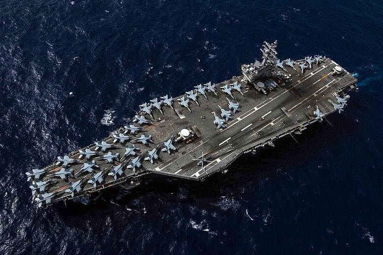 An aerial shot of aircraft carrier USS Ronald Reagan which, together with the USS Nimitz, would be in the South China Sea "to show we are committed to regional security and stability", said the strike group commander.