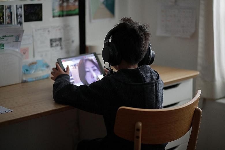 A boy attending an online meeting using an iPad during home-based learning in May. Video-conferencing tools used in HBL can be a boon for shy kids, who feel less stage fright when speaking in class. 