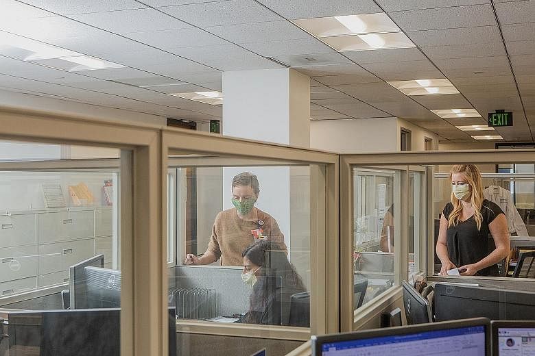A California firm has replaced its open-plan office with protective barriers between cubicles. Kastle Systems, which designs and installs security systems for commercial buildings, has put in place a thermal camera (left) to measure temperatures and 