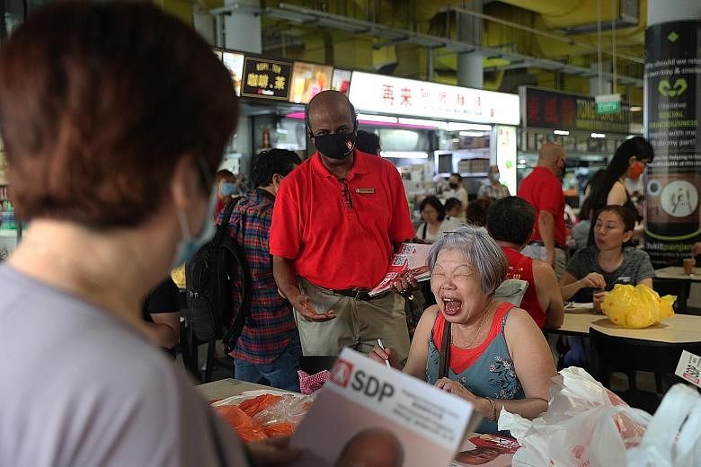 Singapore Democratic Party chairman Paul Tambyah during a walkabout at Bukit Panjang Hawker Centre and Market yesterday. He said Bukit Panjang residents have told him about the need for improvements to bus services in the area while some living near 